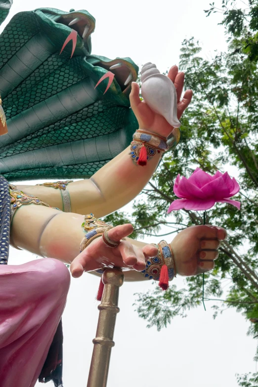 an intricately decorated woman's arm holding flowers