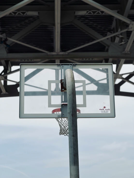 a basketball hoop is up near a pole