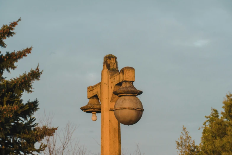 a large stone sculpture sits below some trees