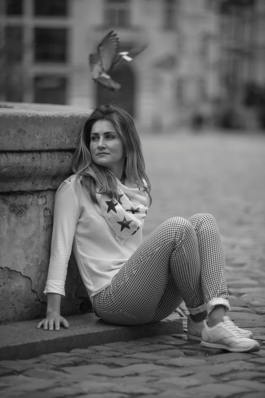 a woman sitting in the middle of the street