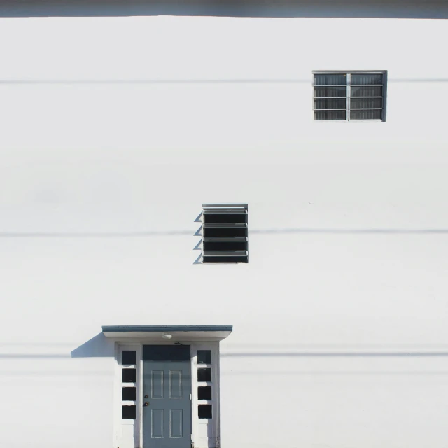 a grey door sits inside the window above a black and white door