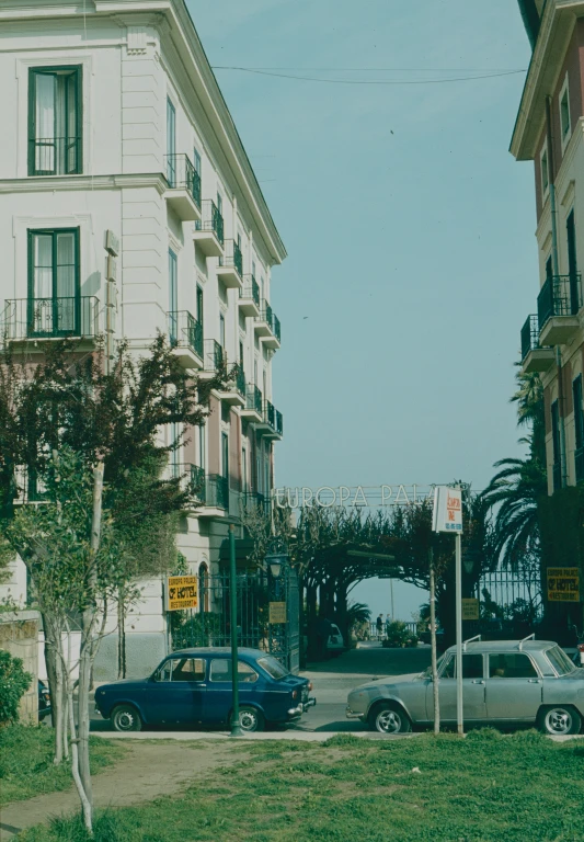 several cars parked on a street in front of a building