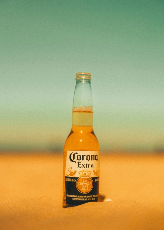 a bottle of corona extra beer on the beach
