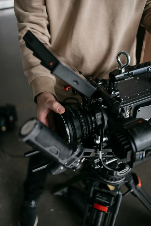 a man sitting in front of a camera on top of a tripod