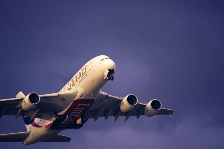 an air plane with landing gear down taking off