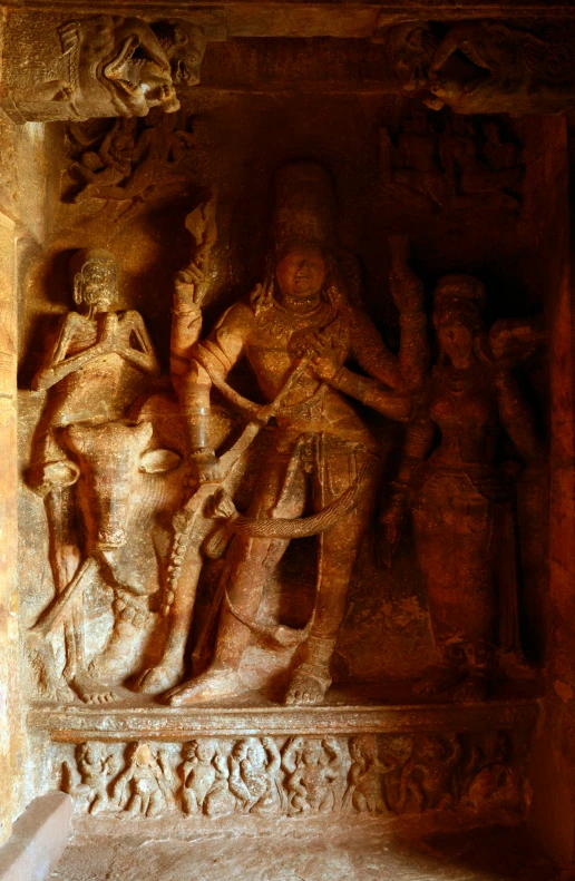 several carved statues adorn the walls of an ancient building