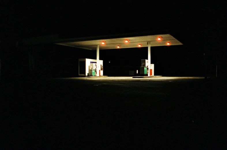 gas pumps with light on them in the dark