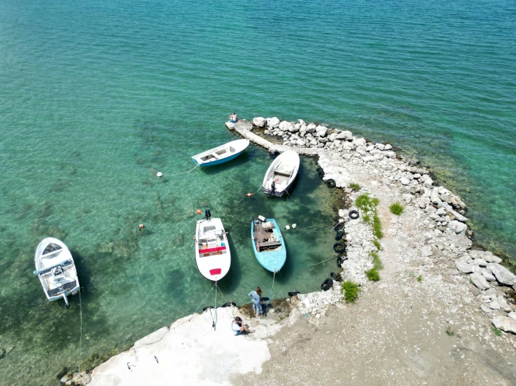 a group of boats sitting in the ocean water