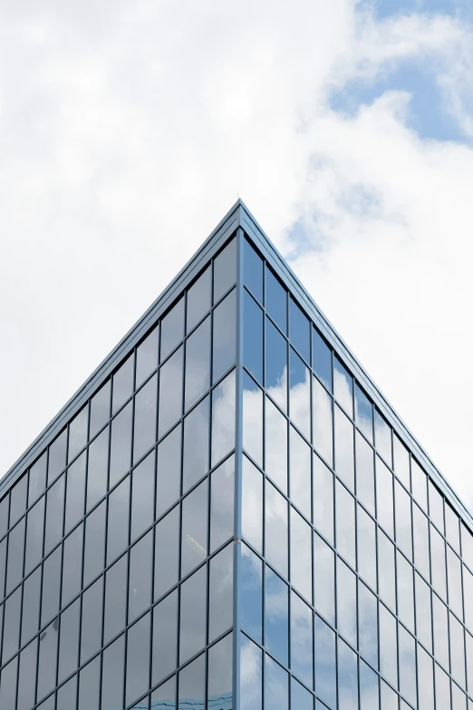 the reflection of an object in a glass building