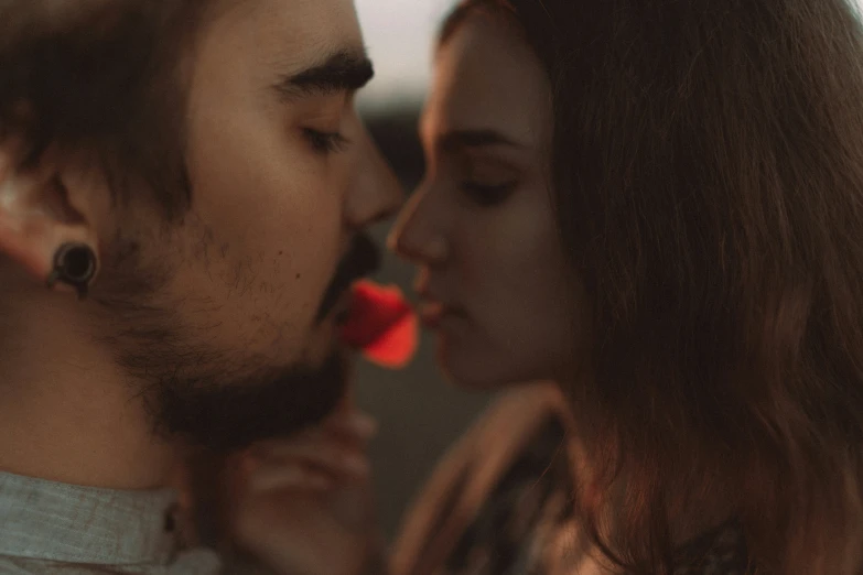 a man and woman sharing a tender moment in the sunset