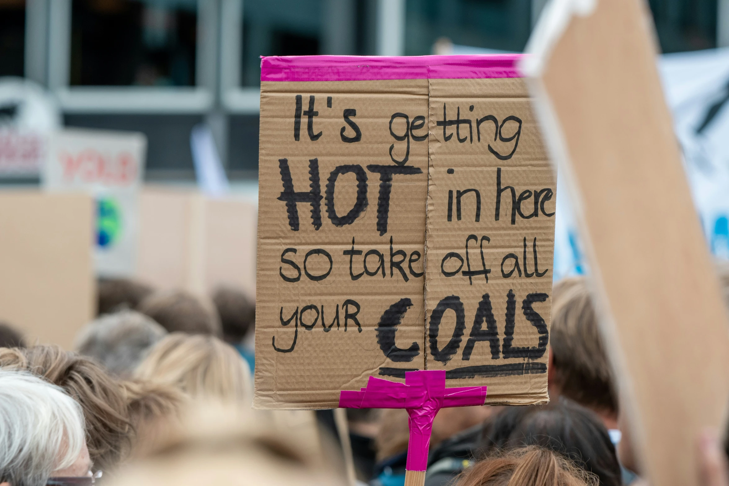 people are protesting with their signs, one saying