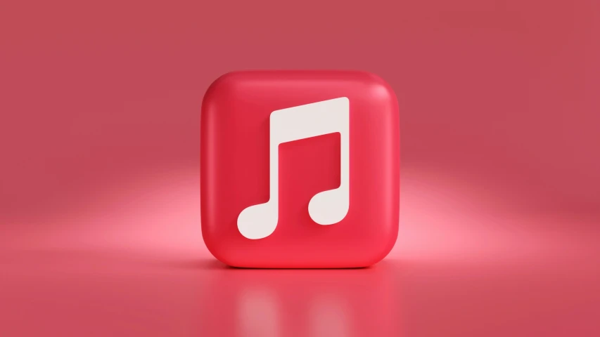 an apple music box sitting on top of a red surface