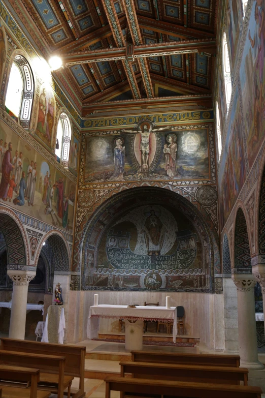 a church with intricate ceiling murals and pews