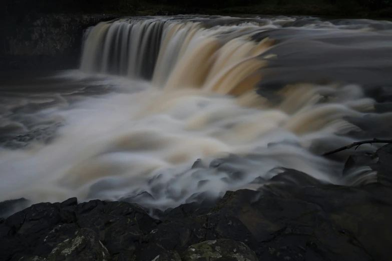 there is a waterfall with a group of large cascases in it