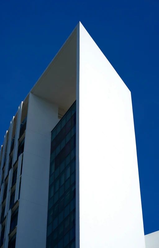 an artistic looking building with a blue sky in the background