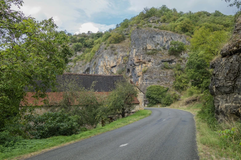 a picture of a country road near a mountain