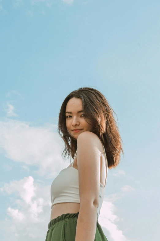 woman with hair pulled back wearing a white top