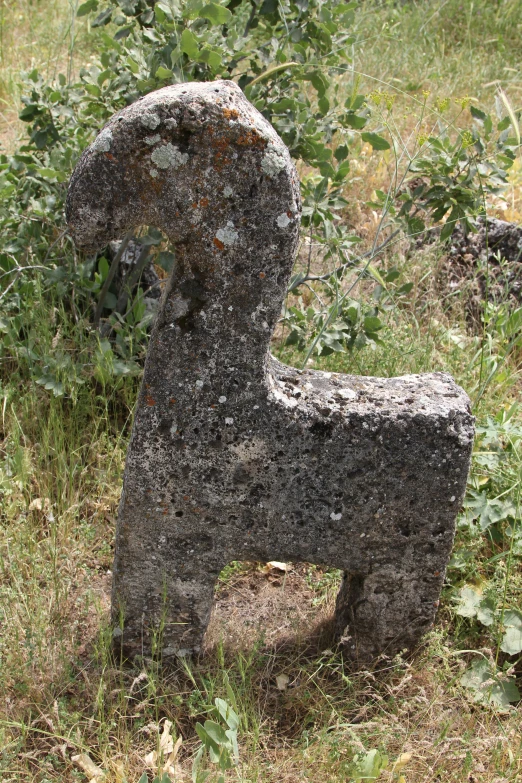 a broken stone sitting in the middle of a field