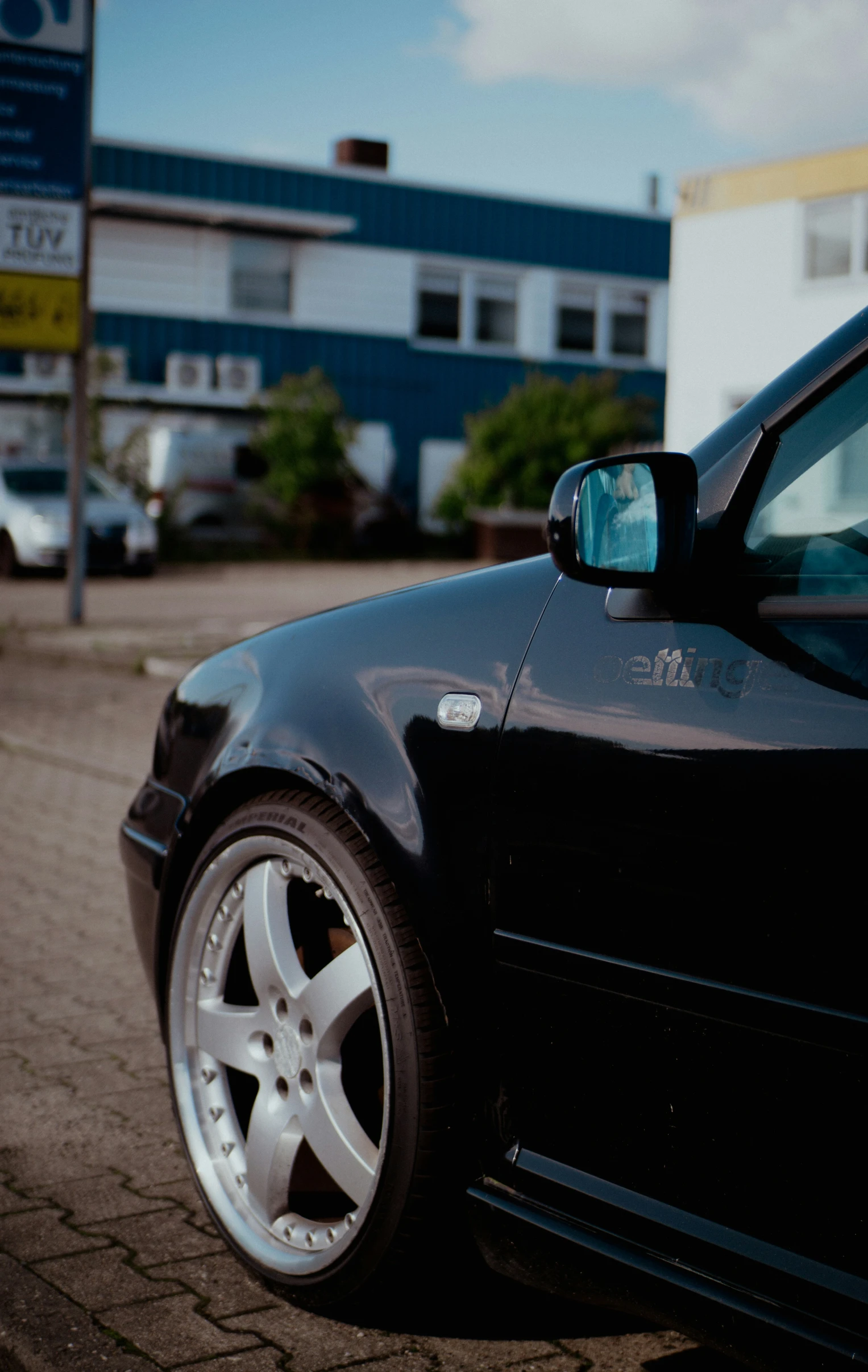 a car with a flat tire parked in a parking lot