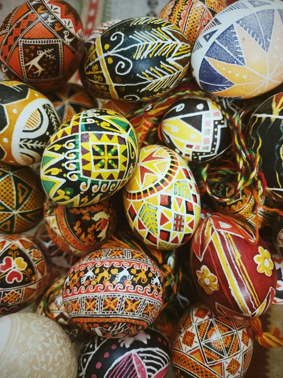 a pile of hand painted eggs on display