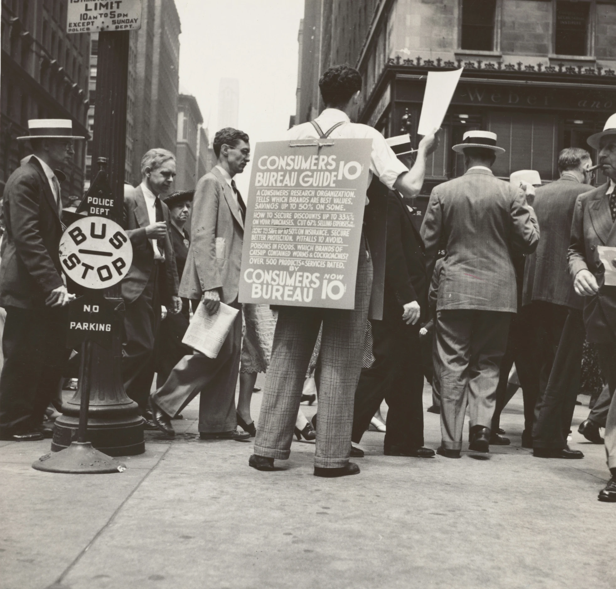 a man holding a sign while walking down the street