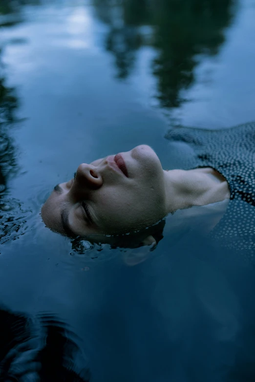 man with water reflection looking off into distance