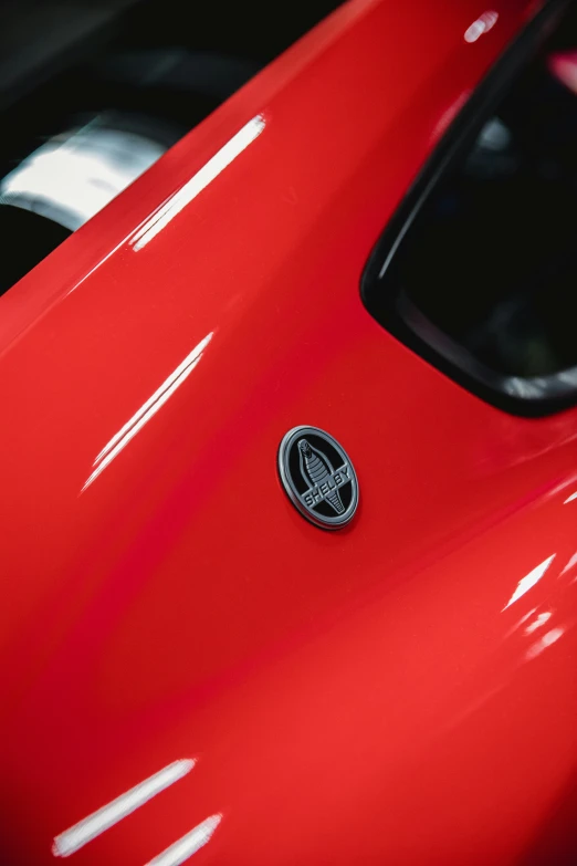 a closeup of a red car with a black decal on the top