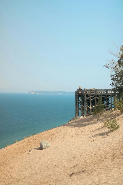 a wooden walkway going down to the ocean on a beach