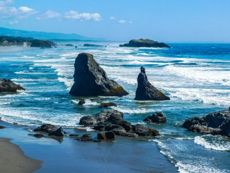 the water is choppy and wavy beside rocks