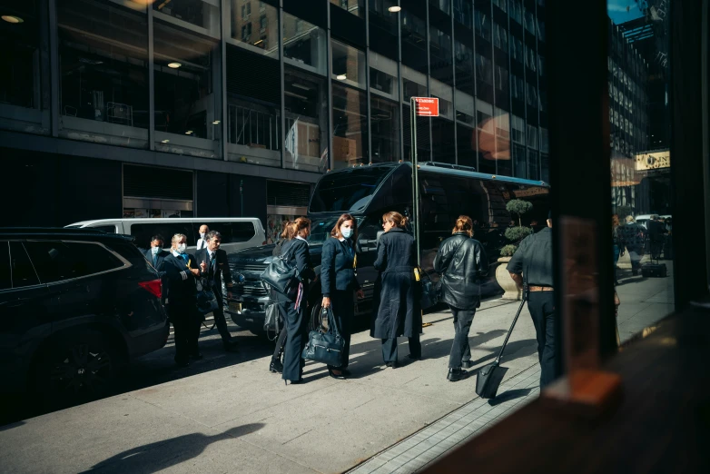 a group of people are gathered outside a large building