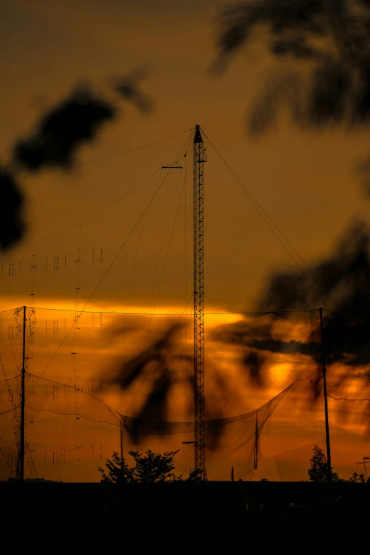 the sun is setting behind some radio towers