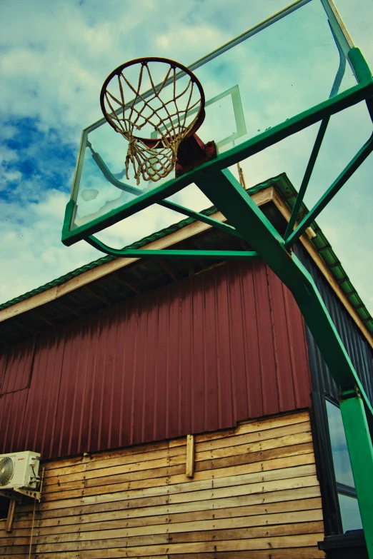 a basketball hoop at a basketball court over looking a building