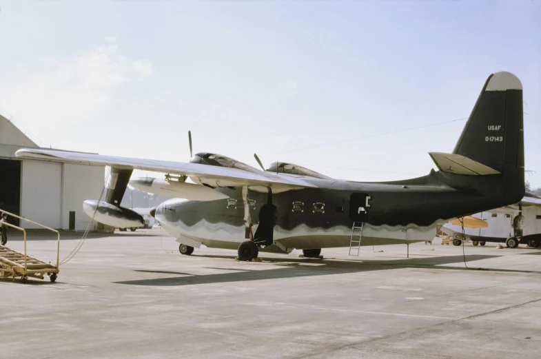 a black plane parked in an air field