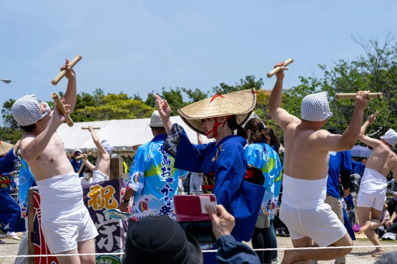 a group of people with s and holding sticks