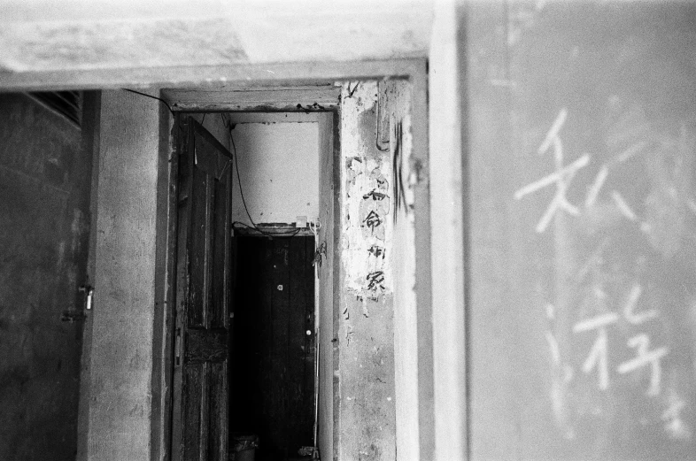 an old doorway has graffiti on the walls