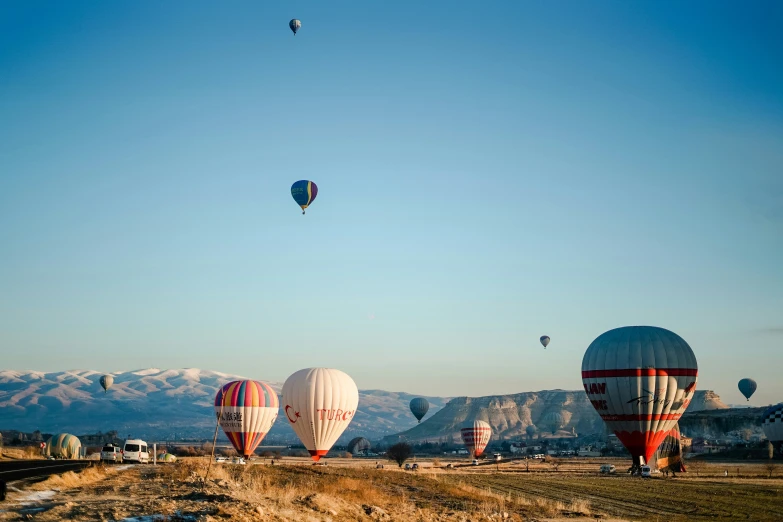  air balloons rise high in the sky as others fly