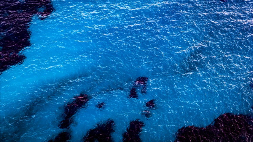 water swirling over the ocean is seen from above