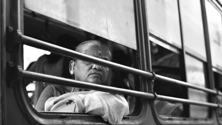 a woman looking out the window of a bus