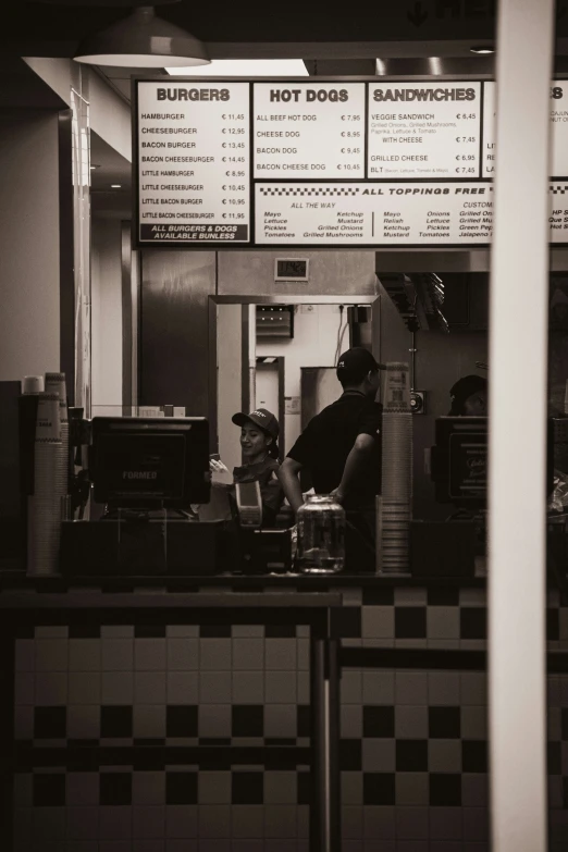 a black and white po of two people in a restaurant