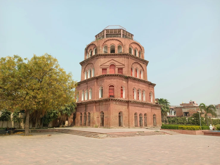 a round building with a small tower near by