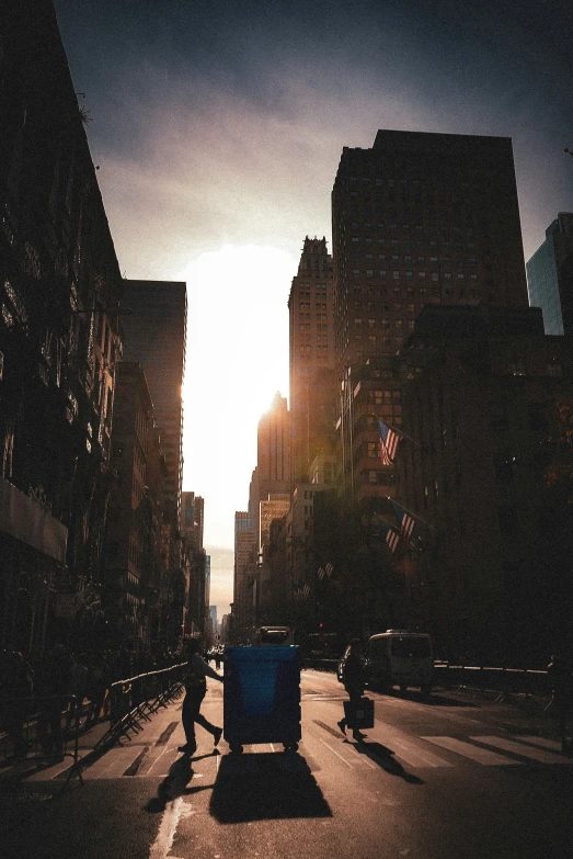 a busy city street with large buildings at the end