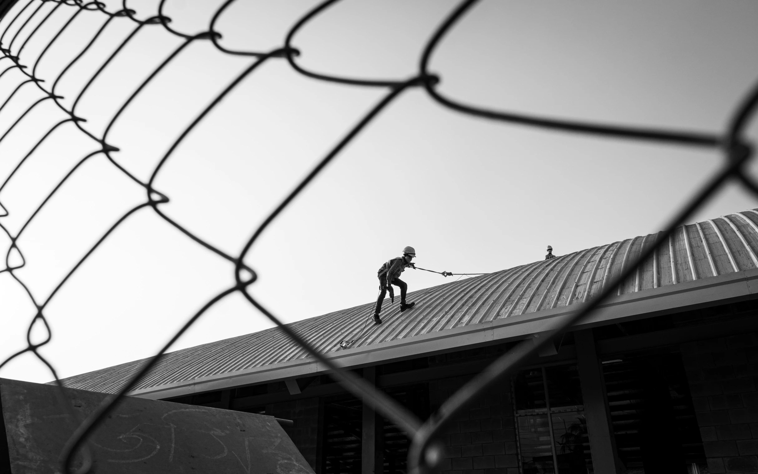 a person on a roof with tennis rackets