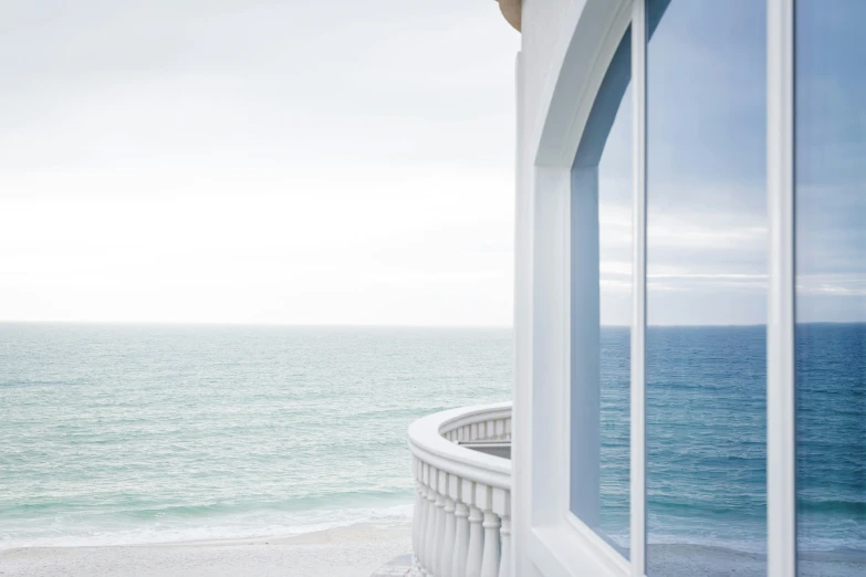 a balcony with ocean view from large window