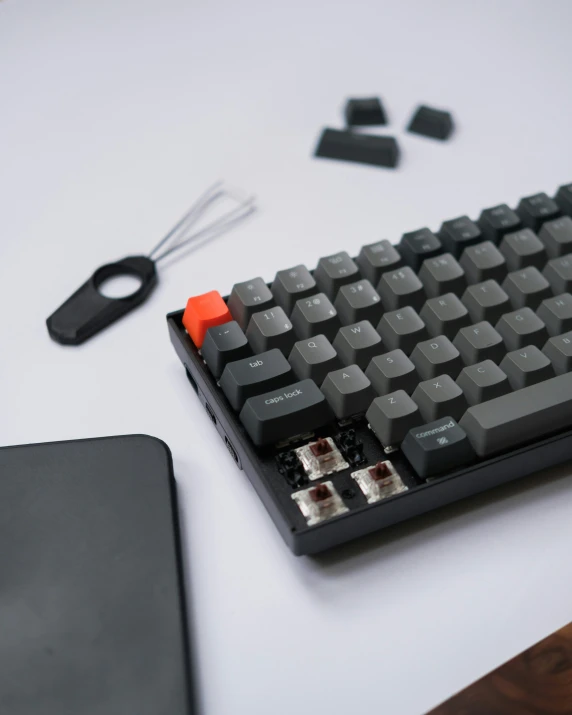 a black and red keyboard sitting next to a black mouse