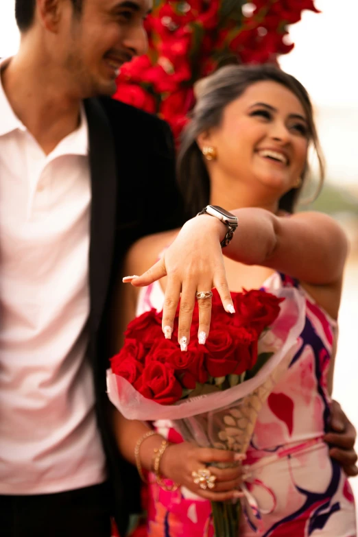 the woman is holding the roses on her wedding day