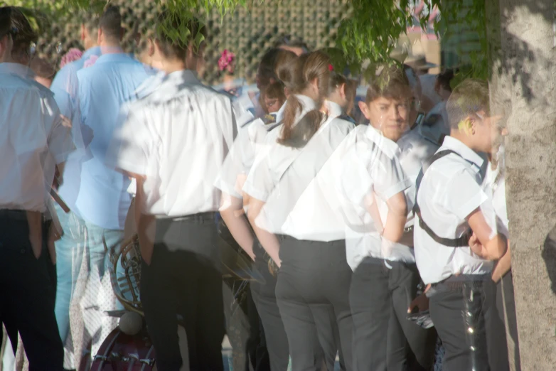 several school boys are walking down the street