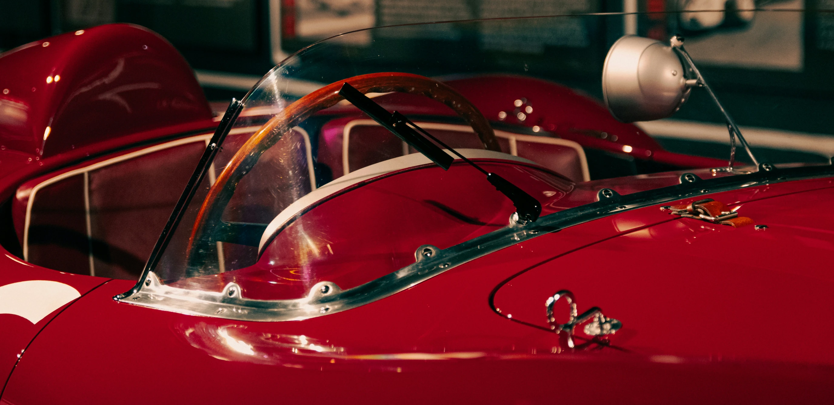 closeup of the front wheel and side of an old model racing car