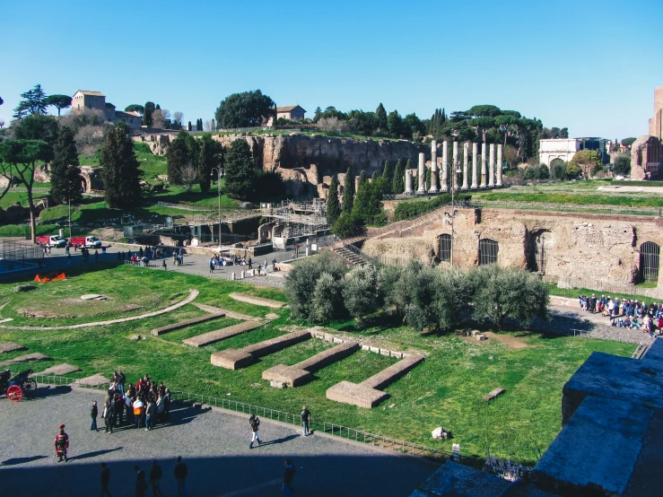 a group of people are gathered on the outside of an ancient building