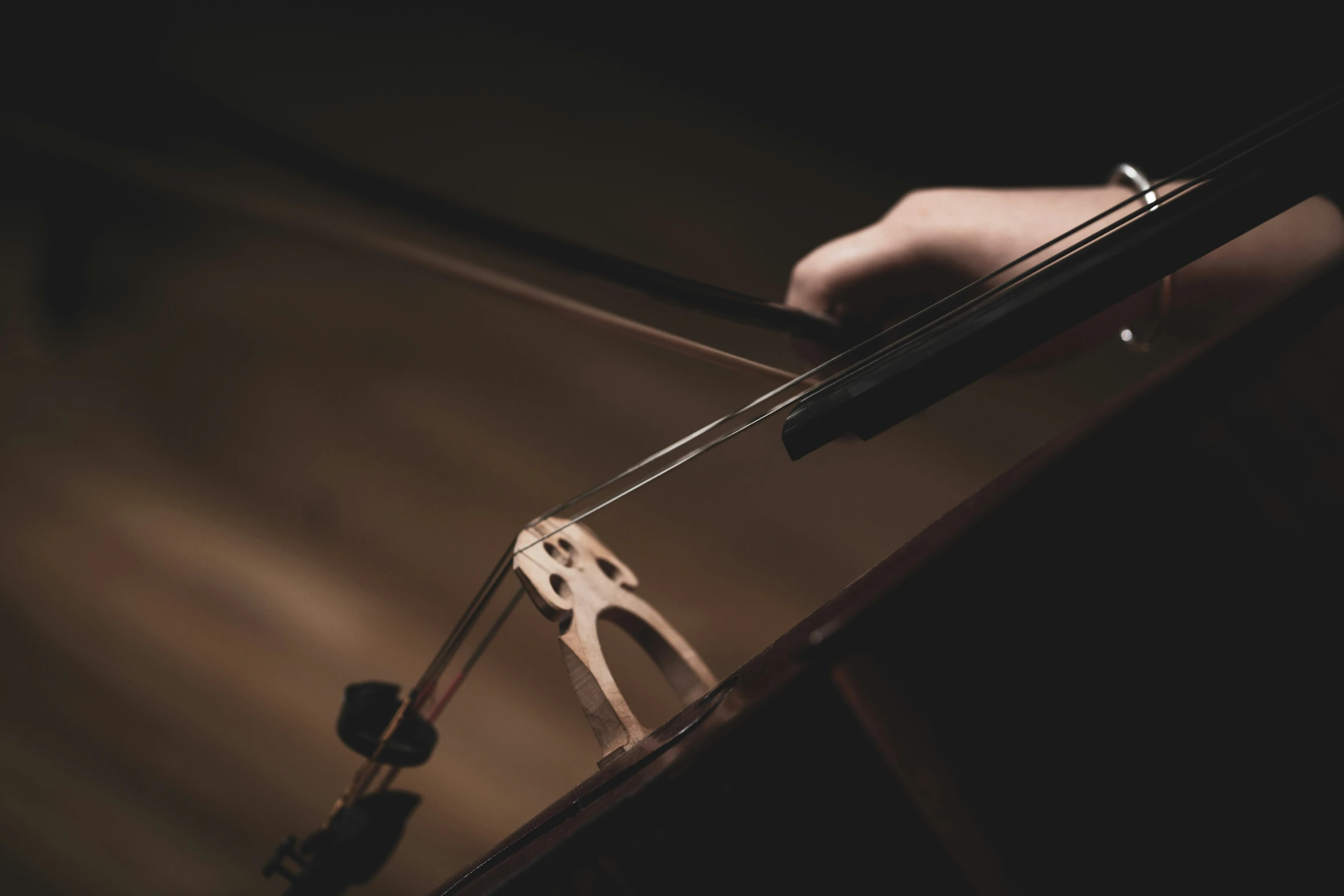 a man standing next to a table holding a violin