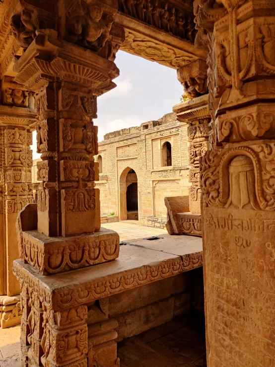 some carved pillars near an old building